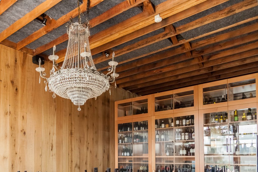 crystal chandelier in front of wine rack