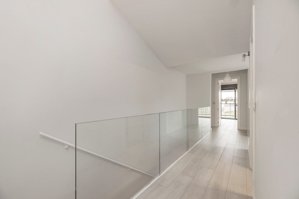 hallway railing with silkscreened glass and a satin finish aluminum structure