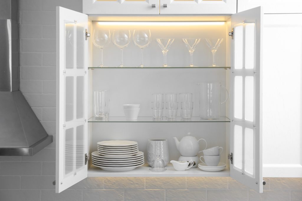 cabinet with crockery and glassware. order in kitchen