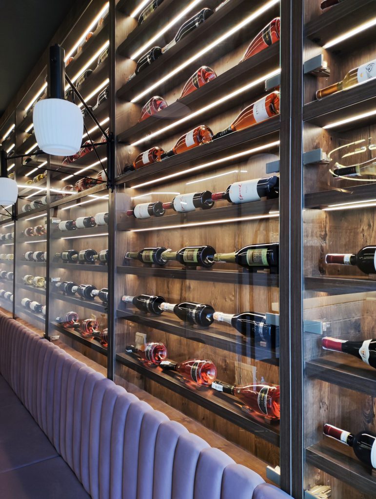 wall of wine bottles collection and interior of restaurant