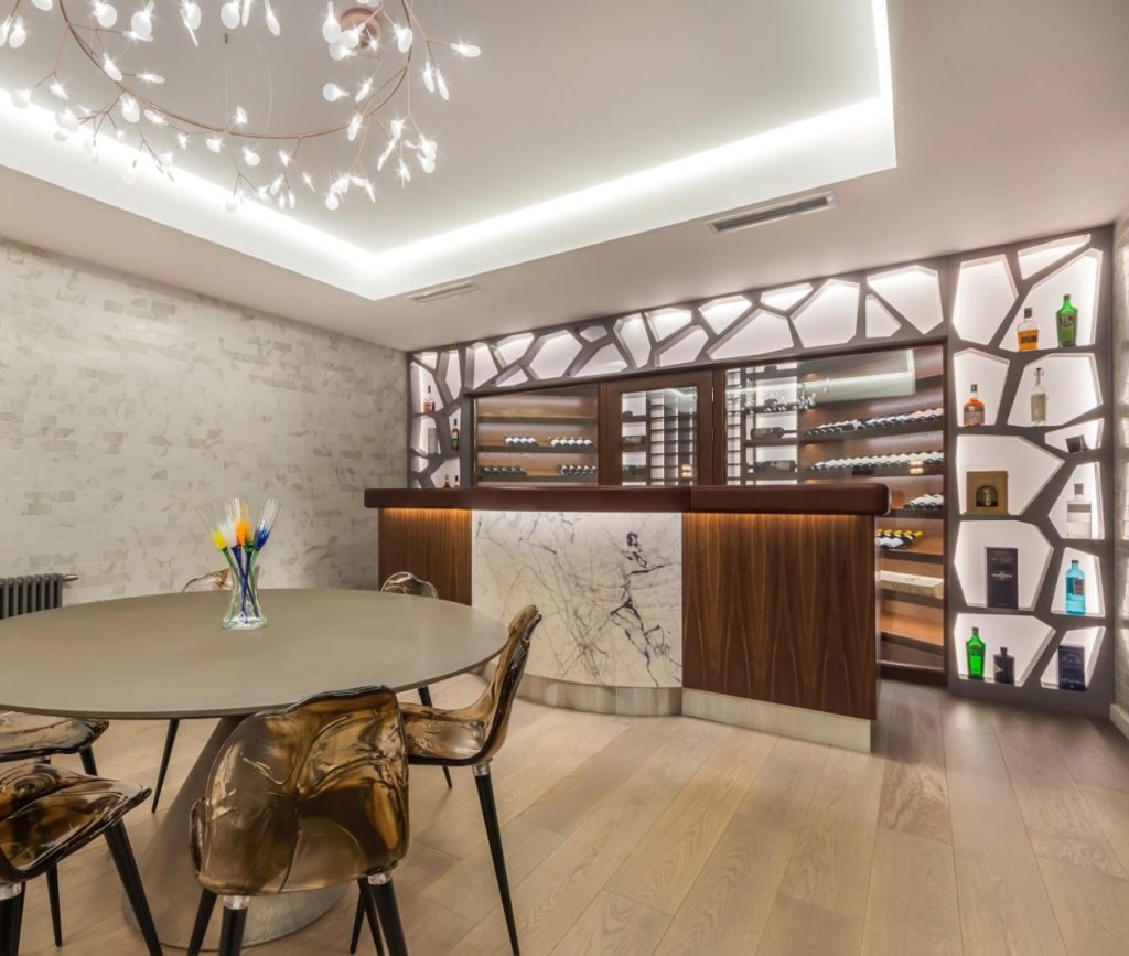 the interior of the living room with an exclusive design with chairs at the table and a bar counter.